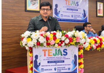 Sansar Green Managing Director Rajeev Singh speaking into a microphone behind a flower-decorated podium with TEJAS signage.